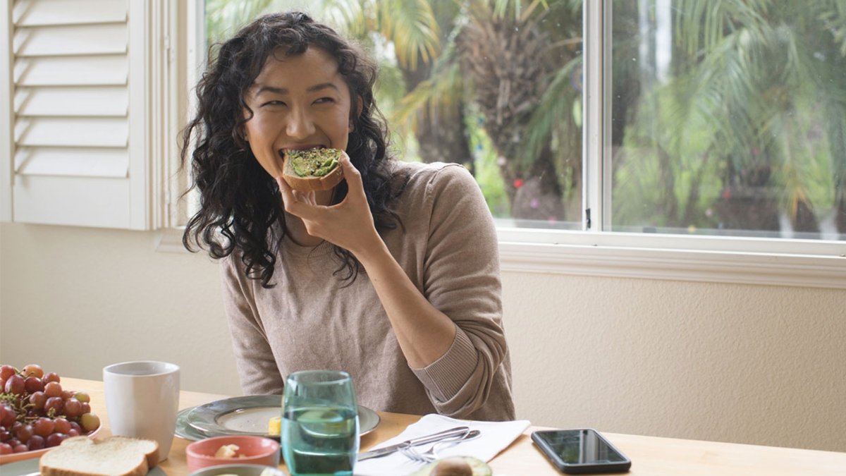 Girl eating avocado